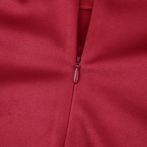 Close-up of invisible zipper construction on a premium red satin mini dress detail