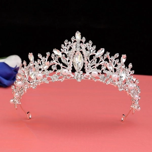 Detailed view of silver bridal crown featuring sparkling rhinestones and white pearls
