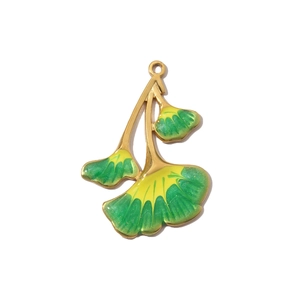 Macro detail of golden ginkgo leaf pendant with green enamel and sparkling glitter finish