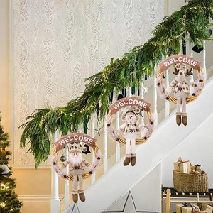 Christmas wreaths with Santa, Snowman, and Reindeer hanging on festive staircase