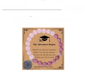 Detail of rose quartz beaded bracelet with compass charm and graduation gift card