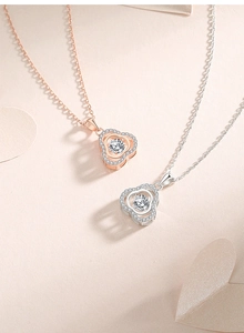 Detail of rose gold and silver flower pendants with sparkling center dancing stones