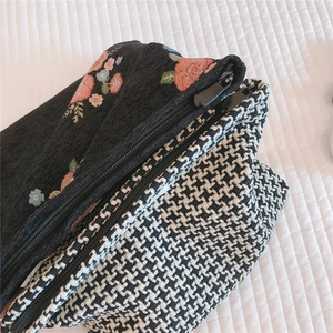 Detail of dual zipper closure on vintage floral jacquard and houndstooth makeup bag
