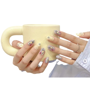 Handmade press-on nails with vintage yellow peach blossoms and pearl accents in round almond shape