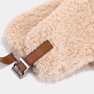 Detailed macro view of the cozy lamb wool texture and faux leather strap with metal buckle