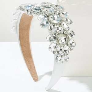 Macro detail of baroque headband with sparkling crystals on a white satin base