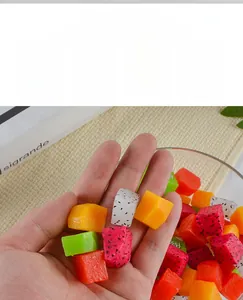 Macro shot of realistic artificial fruit cubes like dragon fruit and mango for DIY crafts