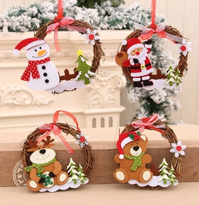Detail of Christmas rattan wreaths featuring felt snowman, reindeer, and Santa Claus characters
