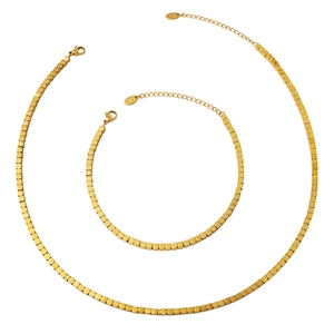 Minimalist gold necklace and bracelet set with square bead design on white background