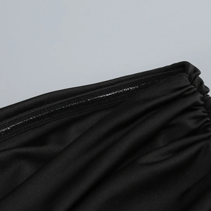 Macro view of black elastic fabric dress with non-slip silicone strip and ruching details