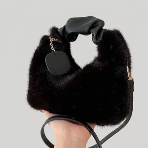 Elegant black faux fur tote bag with ruched leather handle and gold lettering tag