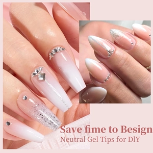 Ombre nude gel tips with silver glitter and rhinestone accents on long coffin nails