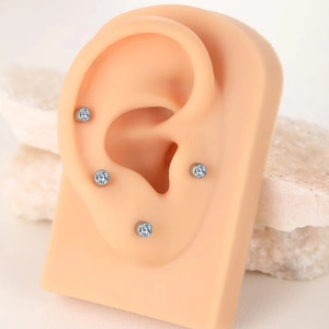 G23 titanium labret studs with sparkling crystals set in a minimalist ear piercing set