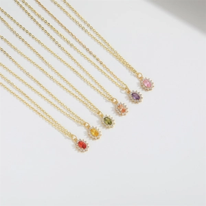 Detailed macro shot of various colorful zircon oval pendants on golden chains