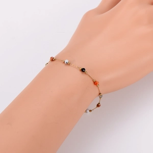 Maillard style gold stainless steel bracelet with colorful beads on a female wrist