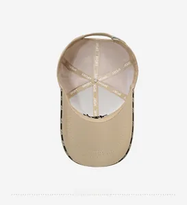 Detailed interior of khaki baseball cap featuring SPORT webbing and metal buckle