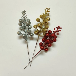 Close-up of glittery Christmas berry stems in gold, silver and red for DIY holiday decor