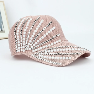 Detail of pink knit baseball cap featuring white faux pearls and shiny rhinestones