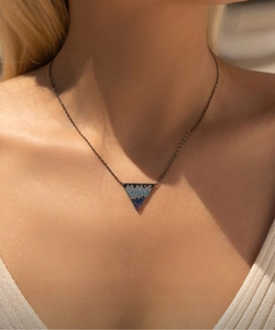 Macro shot of S925 silver necklace with a triangle pendant featuring multi-color gemstones