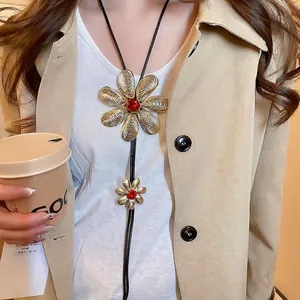 Golden flower pendant necklace with red crystals and tassels on stylish model