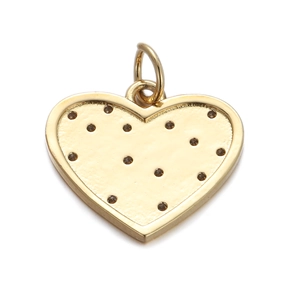 Detail of a gold heart pendant featuring a hammered texture and delicate dark accents