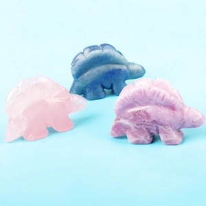 Detailed trio of carved crystal stegosaurus in rose quartz, lapis, and lilac stone