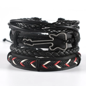 Close-up of multilayer black woven leather bracelet with a metal guitar charm