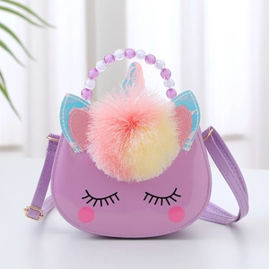 Detail of purple unicorn bag featuring colorful pom-pom and beaded handle for girls