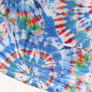 Macro detail of rainbow tie-dye fabric with white parallel stitching on sun hat brim