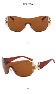 Close-up of frameless Y2K sunglasses with brown lenses and sparkling diamond metal hinges