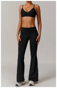 Detail of minimalist V-neck sports bra and high-waist flared yoga pants in black