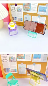 Close-up of colorful mini folding chair phone stands in purple and mint green colors