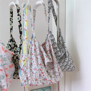 Close-up of lightweight floral cotton tote bags with wide shoulder straps in various prints