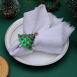 Christmas tree napkin ring with green metal and red rhinestones on holiday table