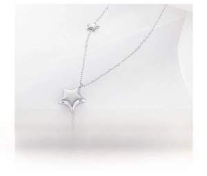 Macro detail of silver star pendant necklace crafted in polished stainless steel