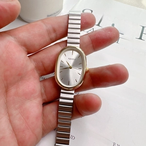 Elegant oval dial women's quartz watch with gold metal case and silver chain strap