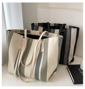 Close-up of woven vertical stripe patterns on large capacity canvas tote bags