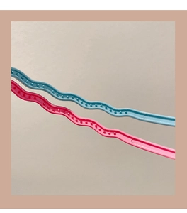 Detail of wavy anti-slip shoulder strips for hangers in pink and blue candy colors