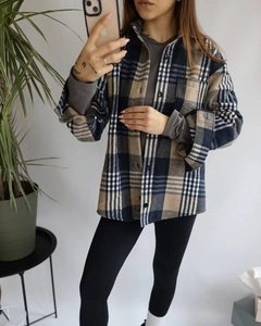 Detail of navy blue and beige flannel plaid shirt with button-down collar and soft texture
