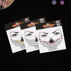 Three Day of the Dead face stickers with colorful rhinestones on a black background
