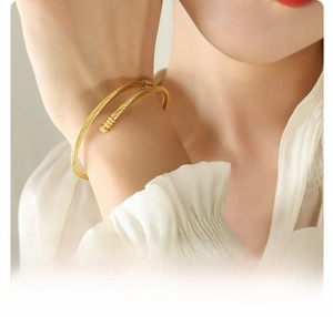 Detailed view of an 18K gold plated surgical titanium steel twisted cable cuff bracelet