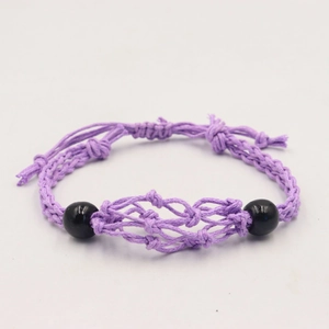 Handmade purple woven net bracelet with black beads and adjustable knot closure