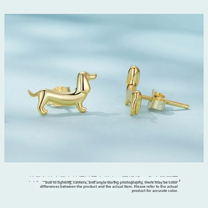 Detailed close-up of golden S925 dachshund stud earrings showing the hallmark stamp