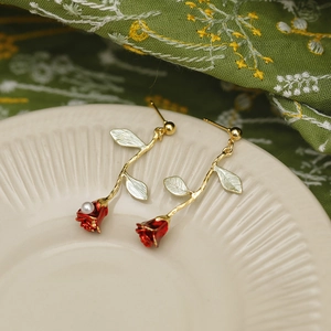 French luxury rose earrings in red enamel and gold finish with a faux pearl drop