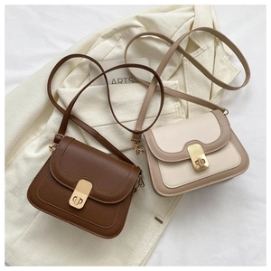 Detail of color-block crossbody bags in dark coffee and beige with golden metal clasps