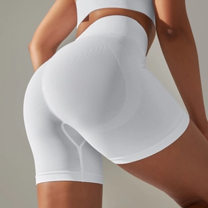 Close-up of white high-waisted seamless yoga shorts showing ribbed fabric and push-up effect