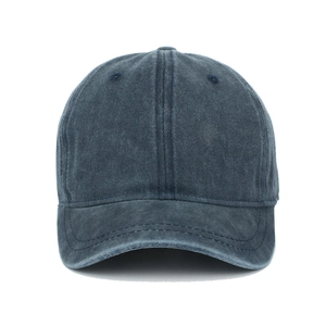 Detail of washed denim baseball cap in dark navy with six-panel design and eyelets