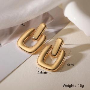 Detail shot of chunky gold geometric link earrings with 4cm length and 16g weight specs