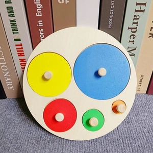 Close-up of wooden Montessori geometric puzzle with 5 colorful circular shape knobs