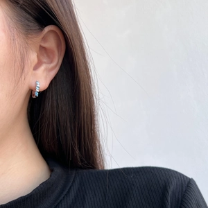 Detailed view of S925 sterling silver ear studs with blue marquise-cut zircon on model